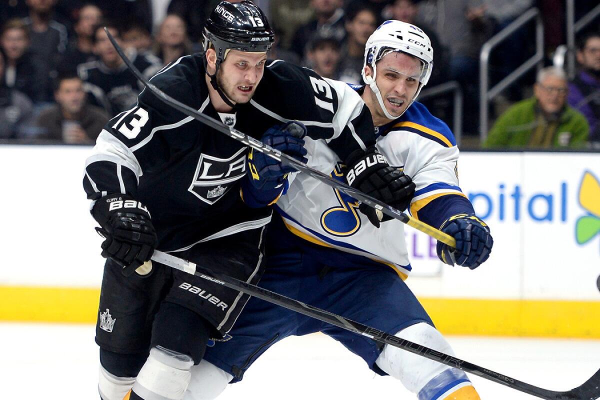 Kings forward Kyle Clifford draws a hooking penalty from Blues center Maxim Lapierre during a Dec. 18 game at Staples Center.