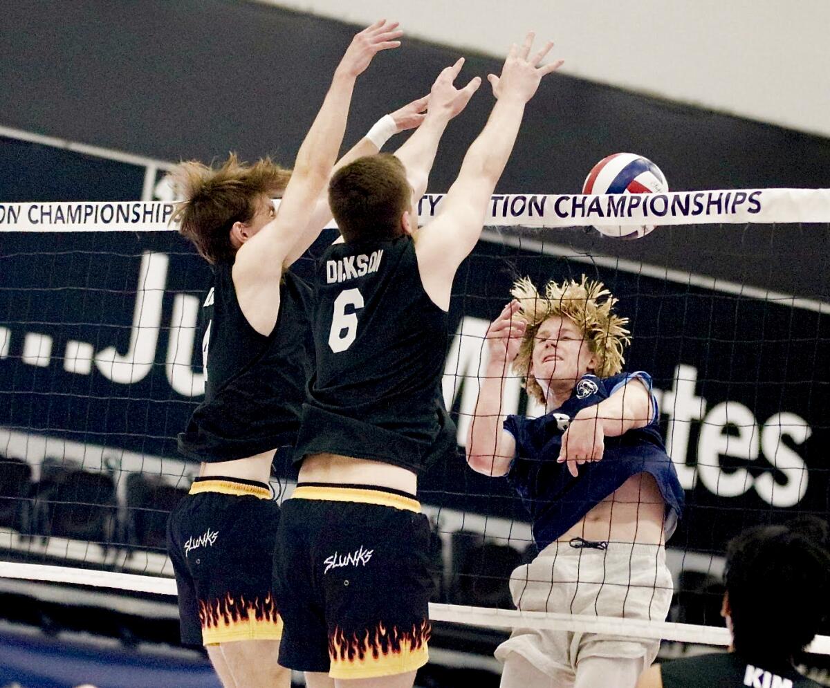 Chatsworth’s Chase Dunn and Justin Dickson block a kill attempt by Palisades’ Blake Pecsok