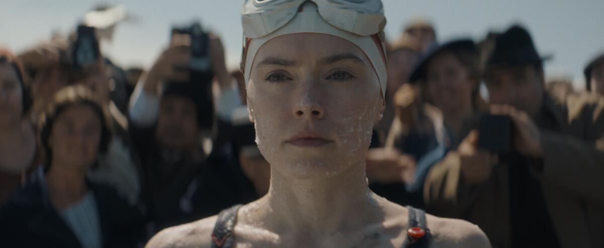 A woman in goggles prepares to swim.