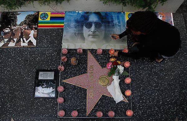Scotti Boettner lights candles as fans gather outside the Capitol Records building to celebrate John Lennon's birthday.