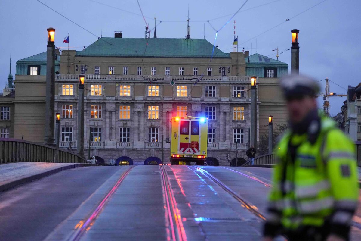 An ambulance drives toward a Charles University building in downtown Prague.