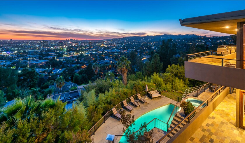 The hillside home includes three levels of decks, balconies and patios, as well as a swimming pool and spa.