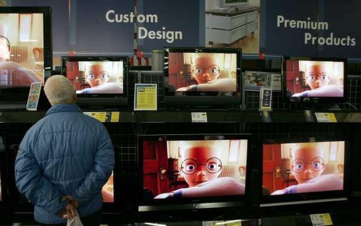 A customer shops for flat-panel televisions at a Best Buy in San Francisco.