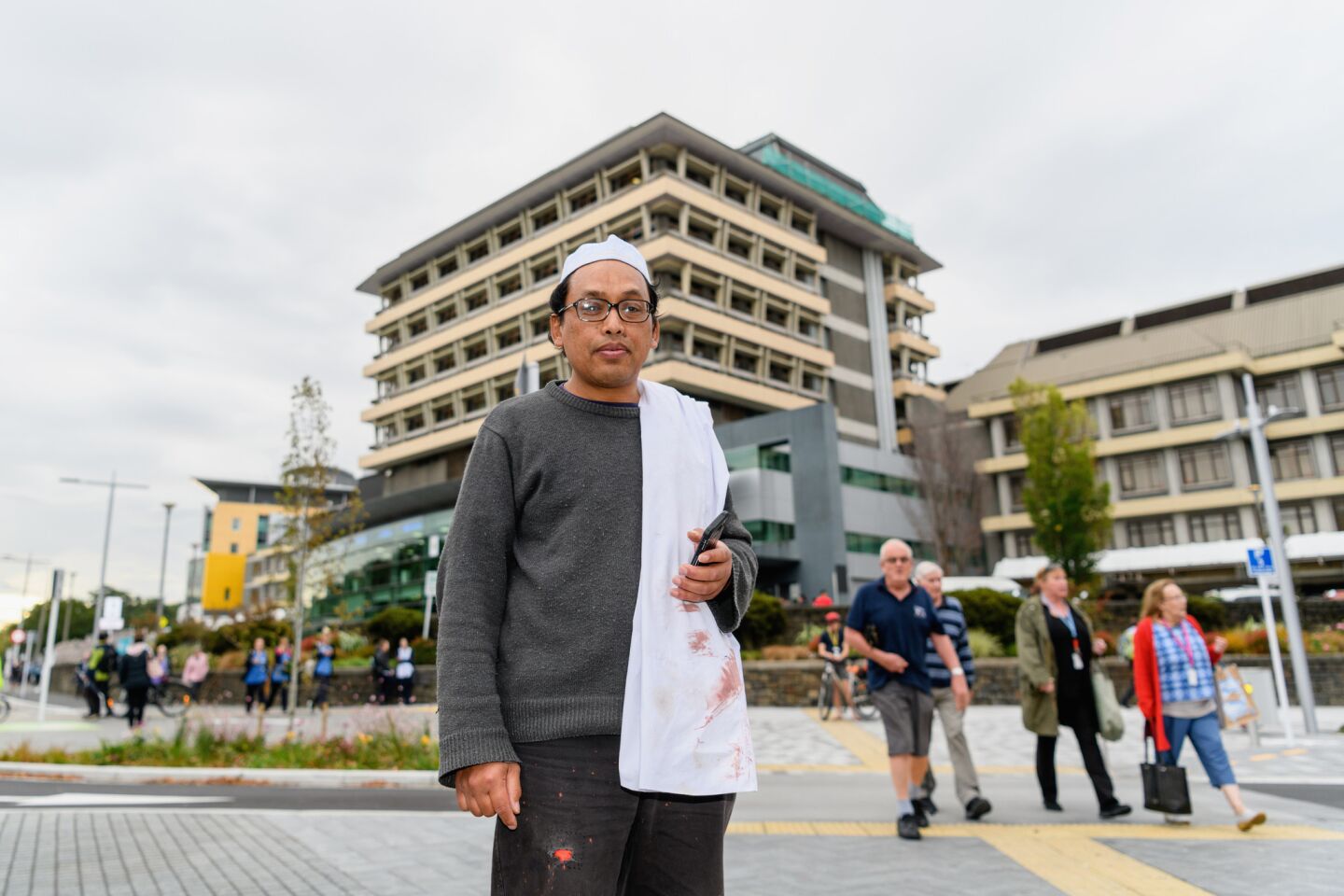 Hamzah Noor Yahaya, a survivor of the shootings at Masjid al Noor mosque, stands in front of Christchurch Hospital at the end of a lockdown Friday.