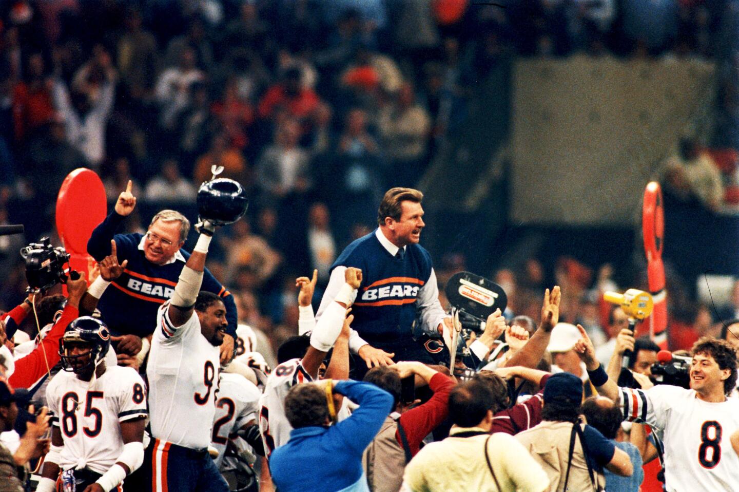 Bears head coach Mike Ditka and defensive coordinator Buddy Ryan are carried around the field after they defeated New England 46-10 to win Super Bowl XX in New Orleans.