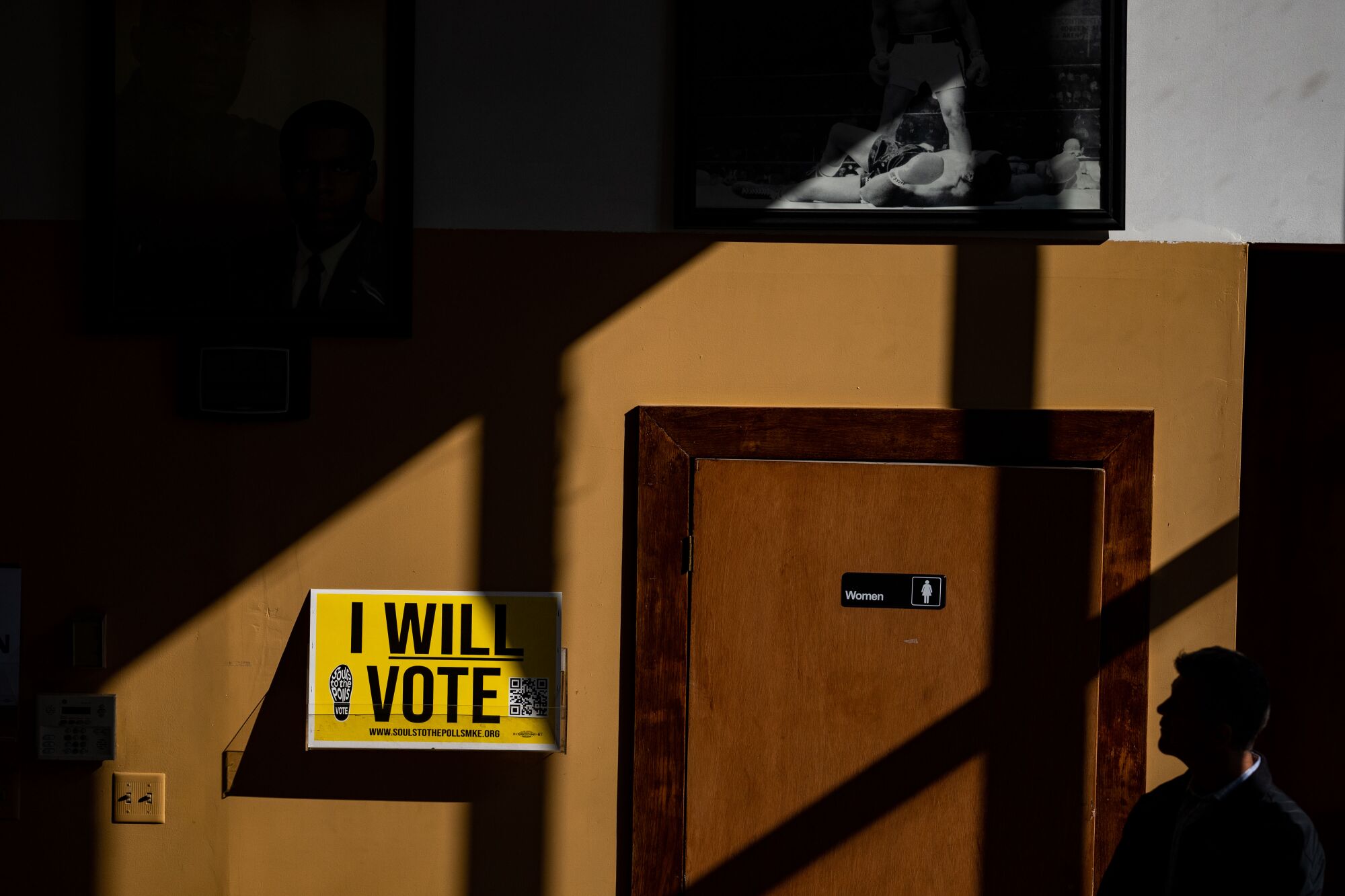 A member of the security detail for Mandela Barnes is cast in silhouette during a Black Maternal Health Roundtable