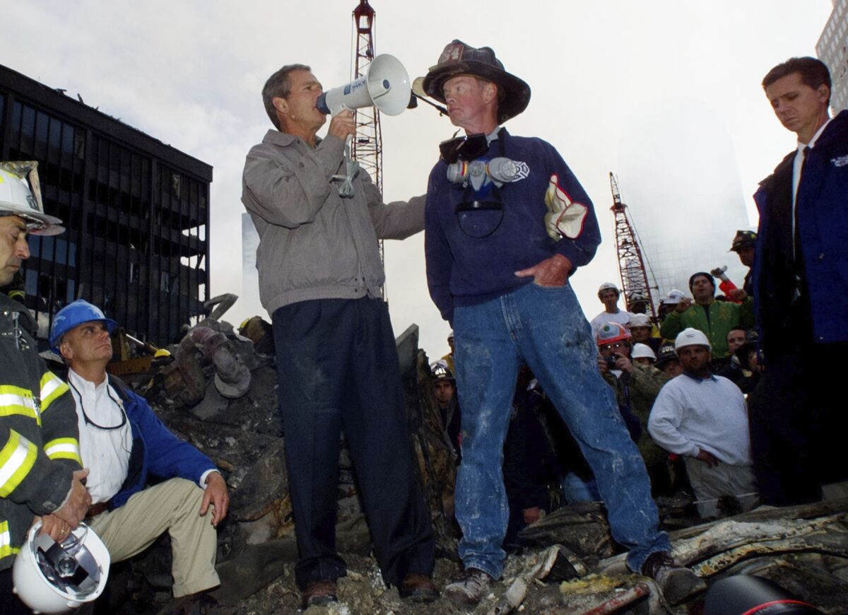  In this Sept. 14, 2001, file photo President Bush stands with firefighter Bob Beckwith in front of the World Trade Center.