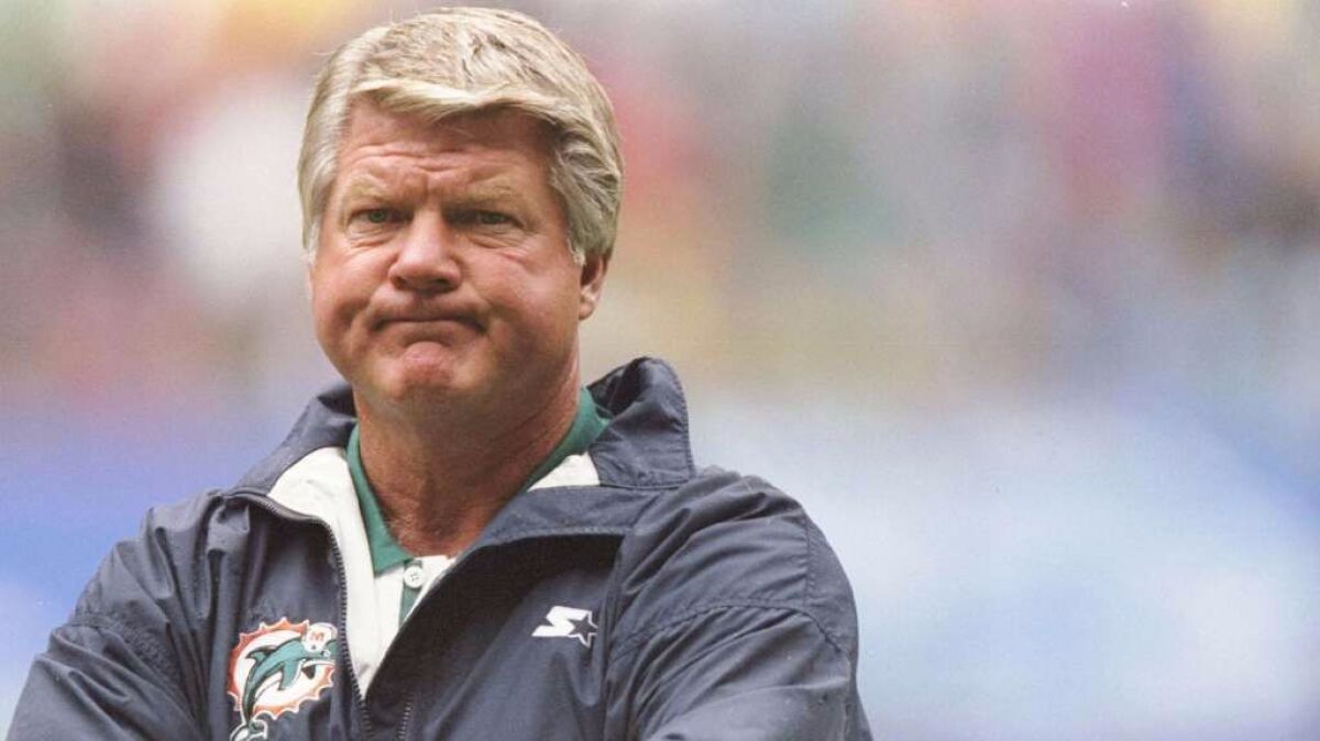 Former NFL coach Jimmy Johnson, pictured in 1997 when he was with the Dolphins, was the first coach to win a college football national championship and a Super Bowl.