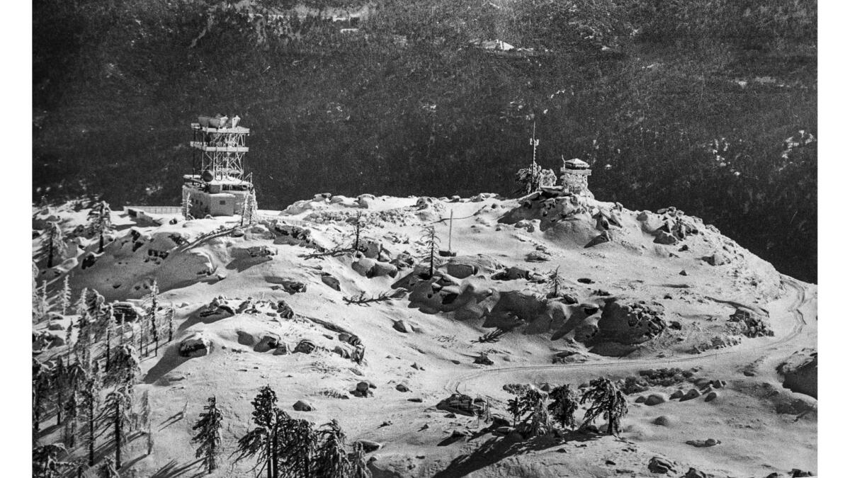 Jan. 8, 1977: Snow on a mountainside near Big Bear Lake gives an otherwordly look to the site of relay station and fire lookout tower.