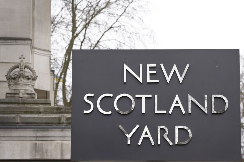 A sign outside New Scotland Yard, the headquarters of the London Metropolitan Police, in London, Tuesday, March 21, 2023. An independent review says London police have lost the confidence of the public because of deep-seated racism, misogyny and homophobia. The report released Tuesday was commissioned after a young woman was raped and killed by a serving officer. (AP Photo/Kirsty Wigglesworth)