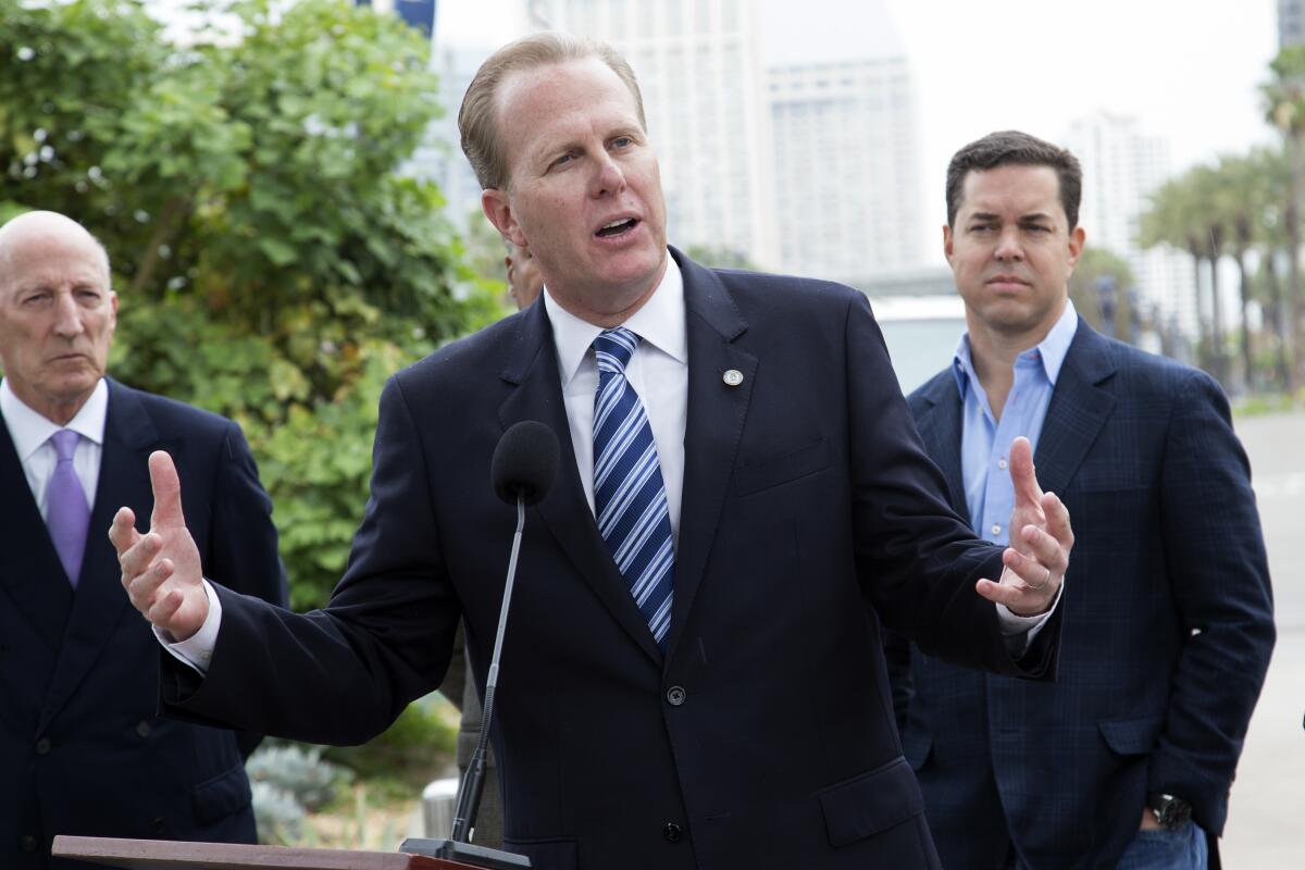 Former San Diego Mayor Kevin Faulconer, center, and real estate broker Jason Hughes, right, in 2015 file photo.