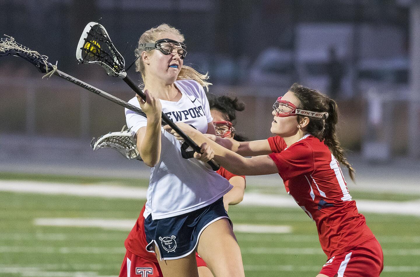 Newport Harbor's Caroline Farley gets pressure from Tesoro's Abbey Schaff, right, and Yujin Lee, behind during a nonleague game on Tuesday, March 13.