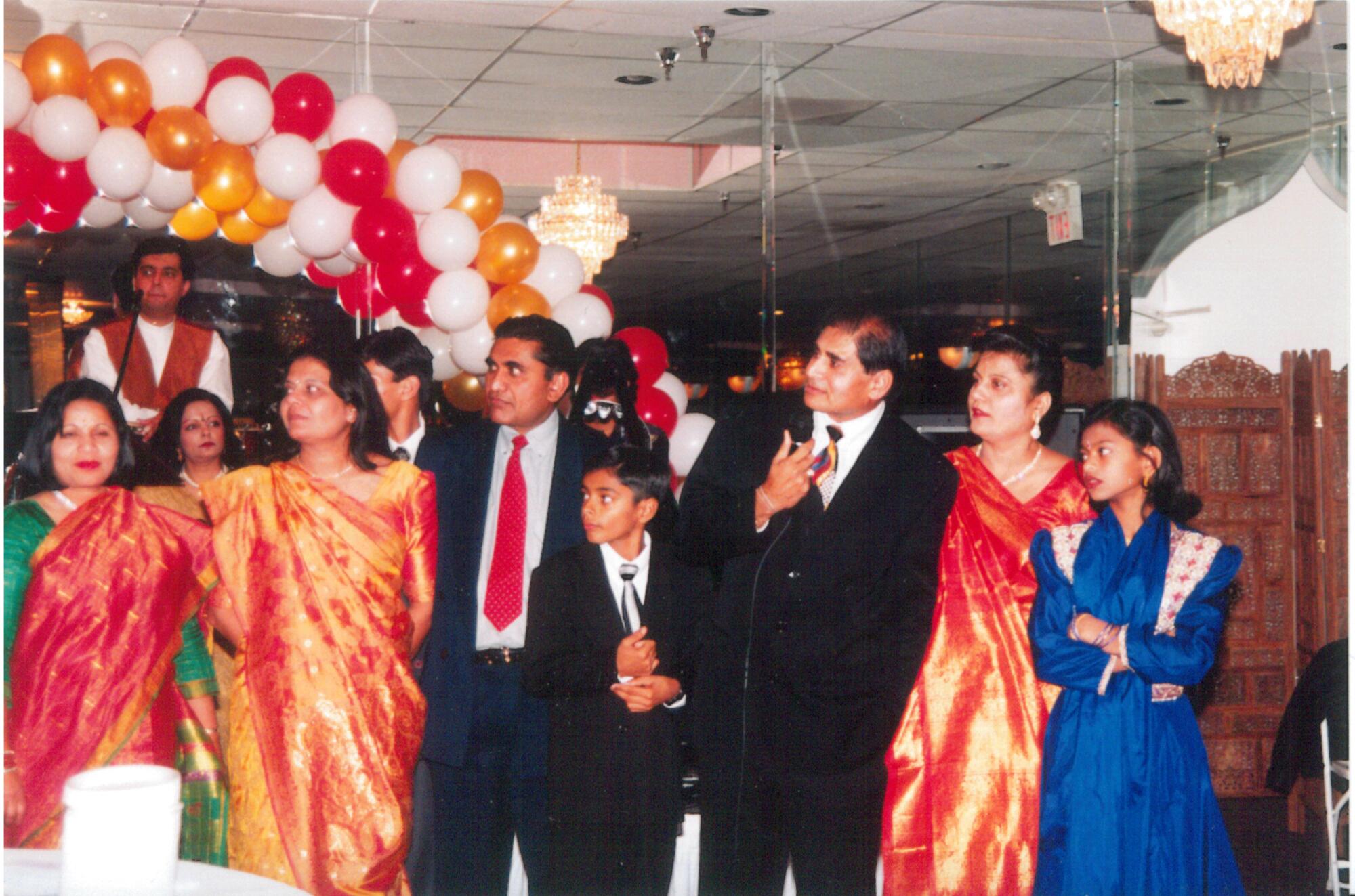 Haresh Jogani, left, and Shashikant Jogani, right, join family members at a celebration.