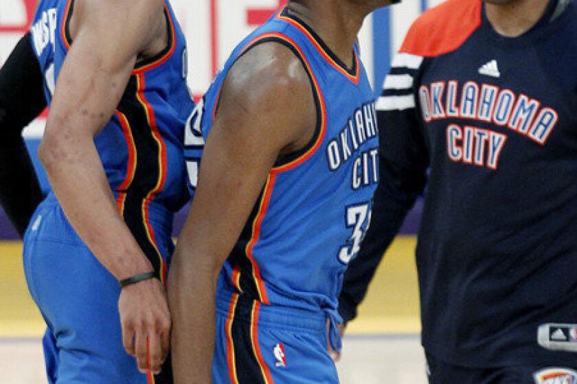 Kevin Durant, center, is congratulated by Russell Westbrook, left, and Derek Fisher after hitting a three-pointer that wound up being the game-winner.