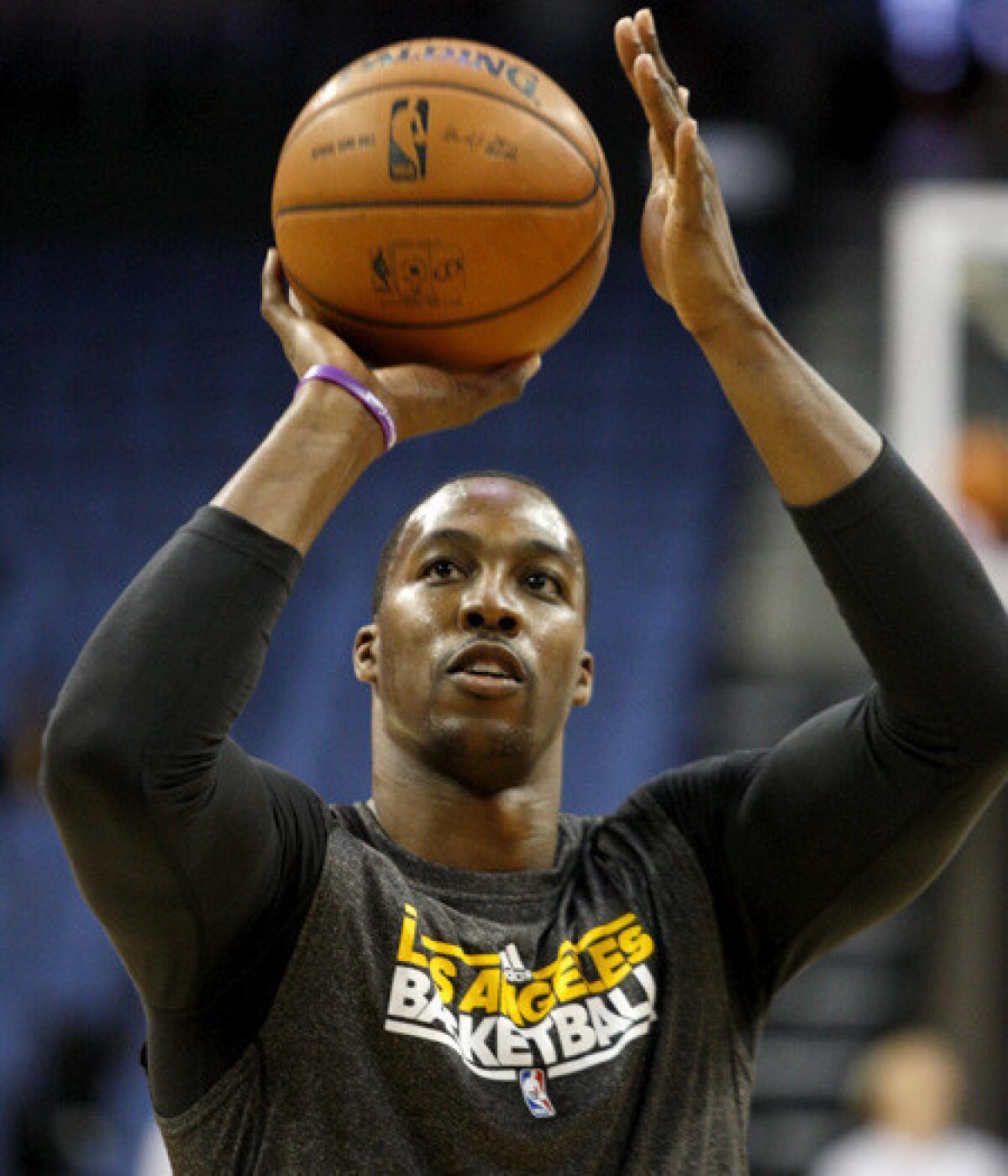 Lakers center Dwight Howard works out before a preseason game last week in Ontario.