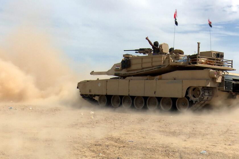 An Iraqi army tank advances in Tikrit on Tuesday during fighting with Islamic State militants.