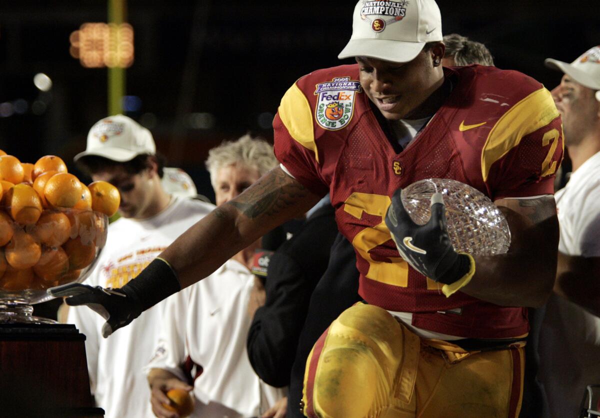 USC running back LenDale White strikes a Heisman Trophy pose holding the National Championship crystal football after USC's 55-19 Orange Bowl victory over Oklahoma on Jan. 4, 2005.