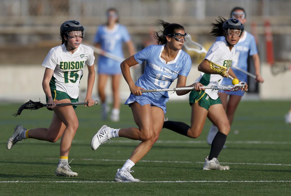 Corona del Mar's Frankie Garcia (15) splits the defense as she charges the goal during Tuesday's match at Edison.