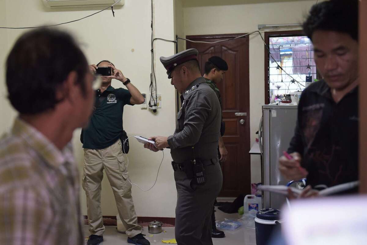 Thai police conduct a search operation at apartment blocks on the outskirts of Bangkok on Aug. 30, 2015.