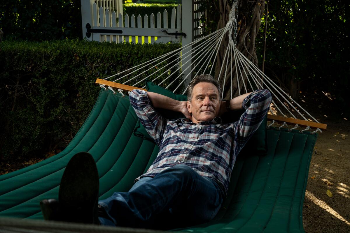 Bryan Cranston lies in a hammock in his backyard.