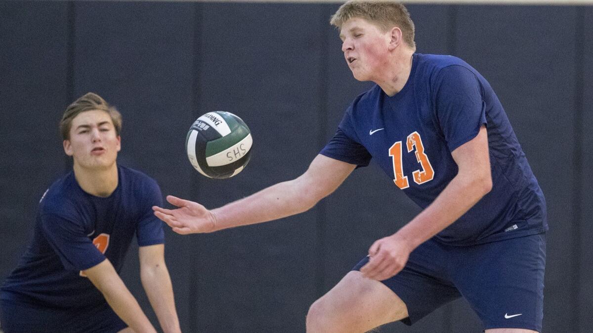 Justin Nishkian, left, shown competing on Feb. 27, 2018, helped the Pacifica Christian Orange County boys' volleyball team to a 25-6, 25-9, 25-18 sweep of Montebello Cantwell-Sacred Heart on Monday.