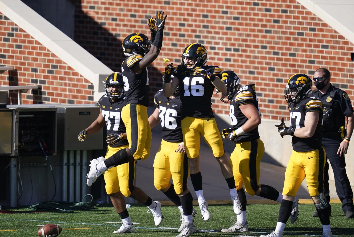 Iowa's Charlie Jones celebrates with teammates after returning a punt 54 yards for a touchdown.