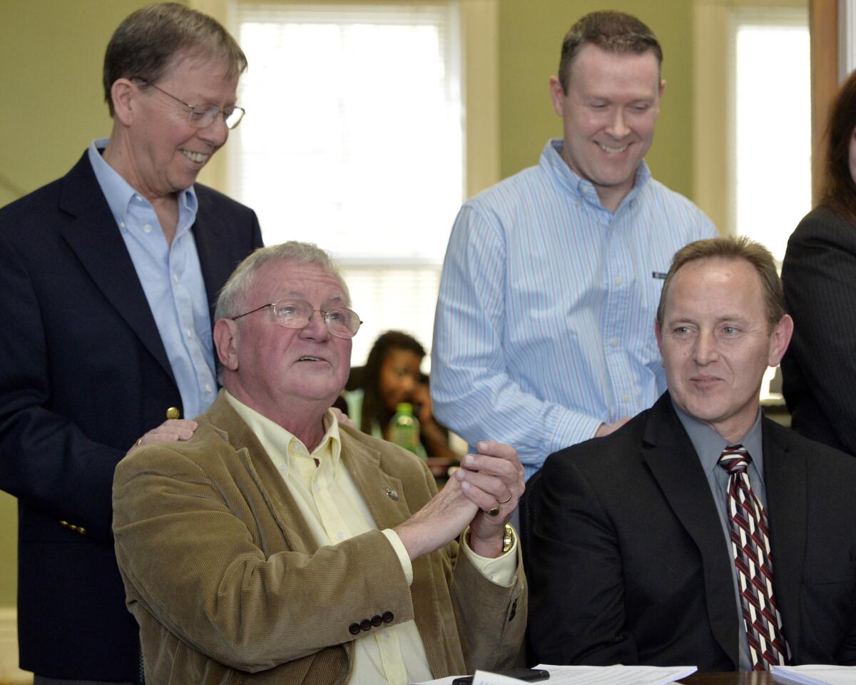Following the Feb. 12 announcement from U.S. District Judge John G. Heyburn that struck down part of Kentucky's same-sex marriage ban, plaintiffs Luke Barlowe, front left, his partner, Jim Meade, rear left, Randy Johnson, front right, and his partner, Paul Campion, answer reporters' questions. The judge ordered that Kentucky recognize same-sex marriages legally performed in other states and opened the door for the ban to be struck down entirely.