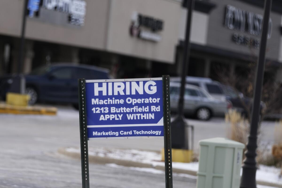 A hiring sign is seen in Downers Grove, Ill.