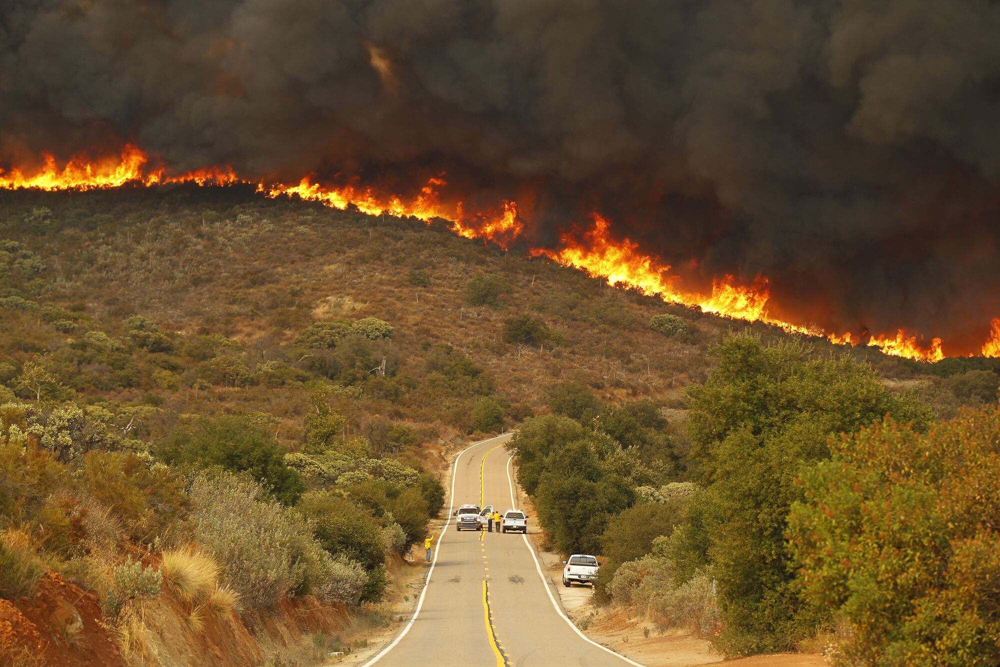 San Diego Sheriffs and CDF firefighters stage on Lyons Valley Road during the Valley fire.