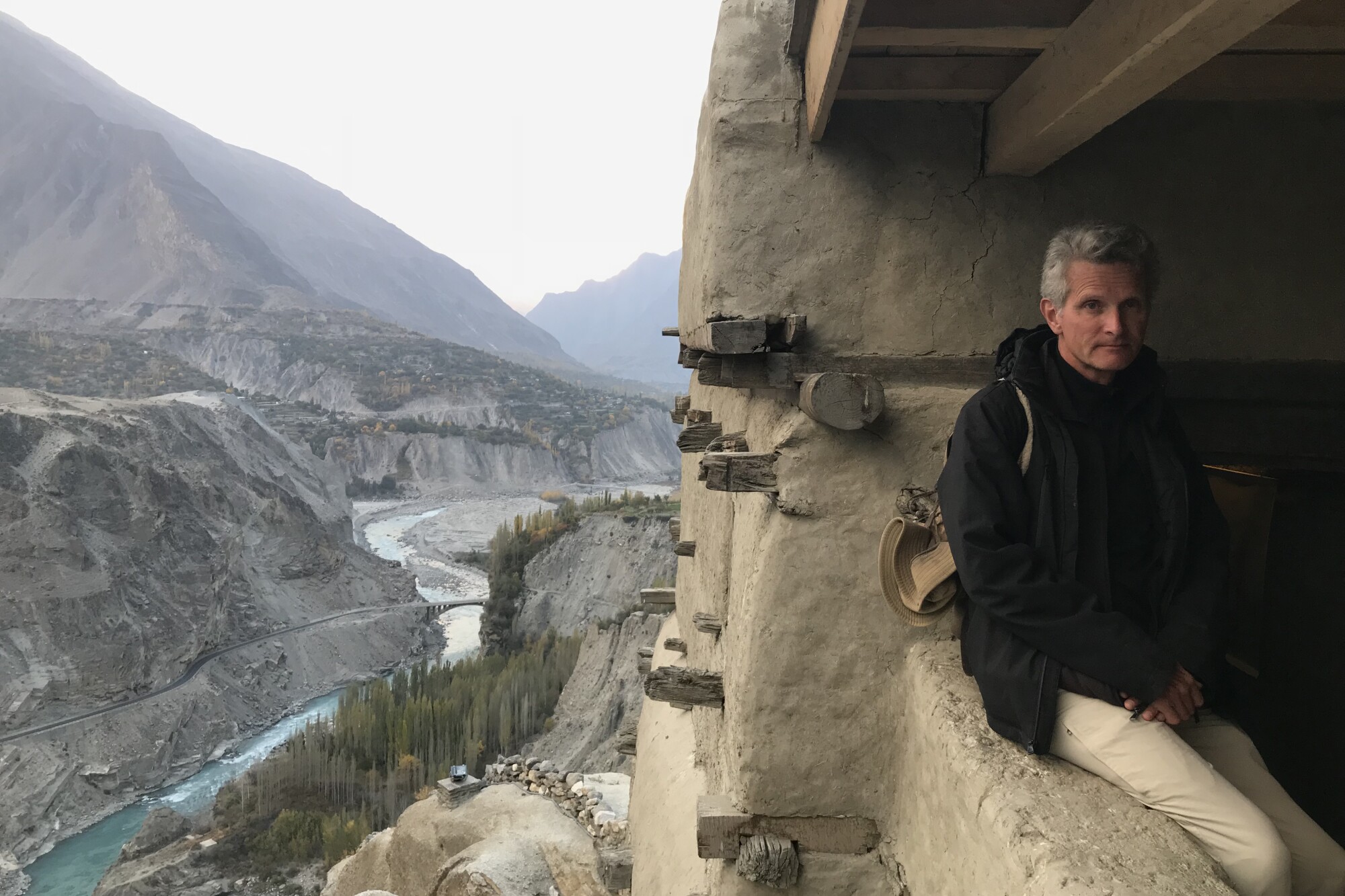 Paul Salopek sits in a parapet of mud fortress in Gilgit-Baltistan, Pakistan.