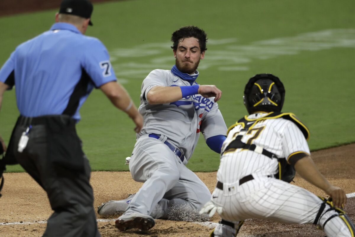 Cody Bellinger scores off a single by Corey Seager as San Diego Padres catcher Francisco Mejia drops the ball making the tag.