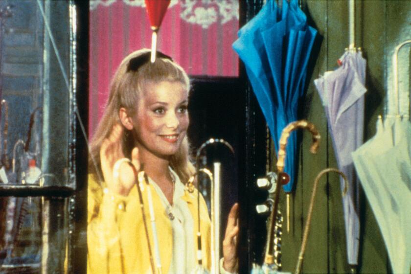 from the movie THE UMBRELLAS OF CHERBOURG opening at the Nuart on Friday April 23. Genevieve (Catherine Deneuve) ZEITGEIST FILMS