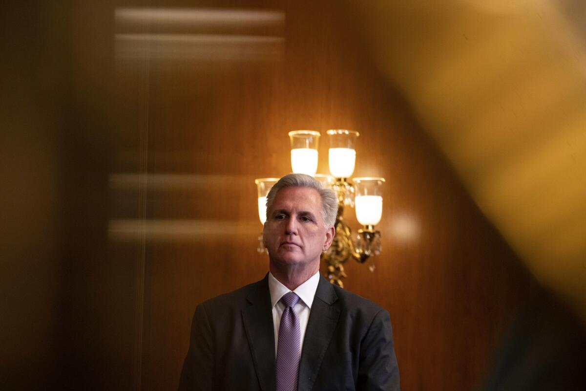 House Speaker Kevin McCarthy listens during a news conference