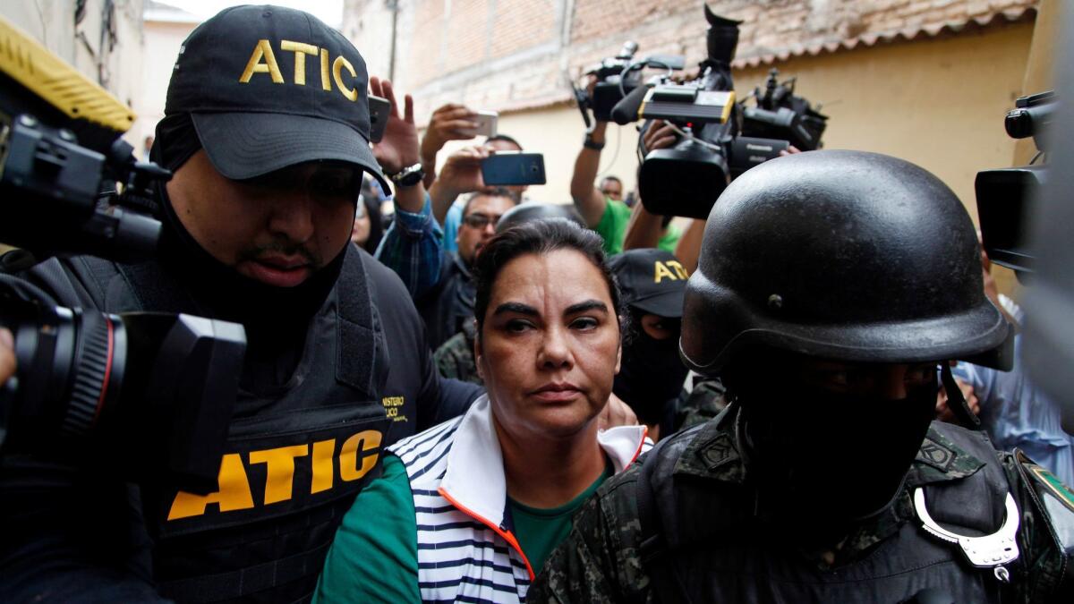 Officers escort Honduras' former first lady, Rosa Elena Bonilla, from a police station in Tegucigalpa, the capital, on Feb. 28, 2018.