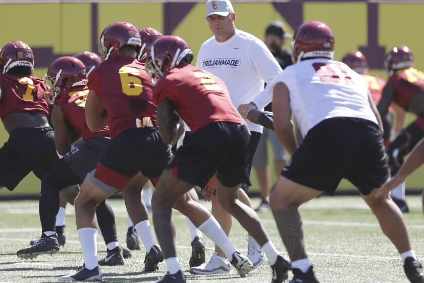 LOS ANGELES, CALIF. - AUG. 2, 2019. Head football coach Clay Helton runs players through warm-ups during the opening of training camp at USC on Friday, Aug. 2, 2019. Helton heads into his fifth season as the Trojans' head coach with a record of 32-17. (Luis Sinco/Los Angeles Times)