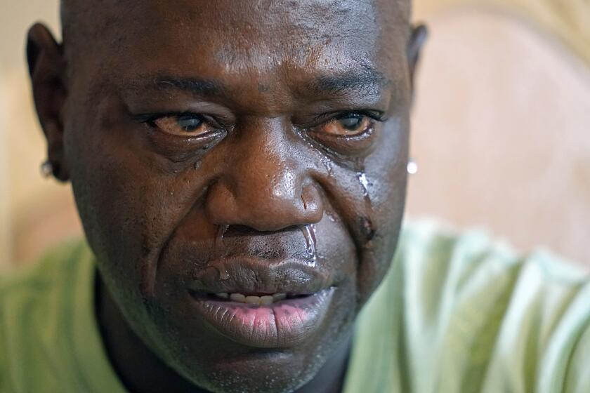 Aaron Larry Bowman cries during an interview at his attorney's office in Monroe, La., Thursday, Aug. 5, 2021, as he discusses his injuries resulting from a Louisiana State trooper pummeling him with a flashlight during a traffic stop in 2019. (AP Photo/Rogelio V. Solis)