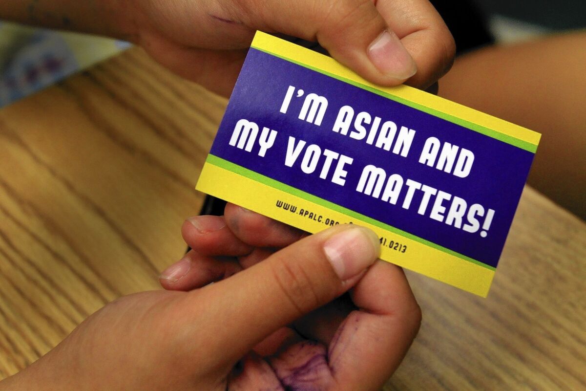 Stickers from the Asian Pacific American Legal Center aim to make a point at a presentation at Cal Poly Pomona before the November 2012 election. Asian American voters have shifted strongly behind Democrats, which worries Republicans.