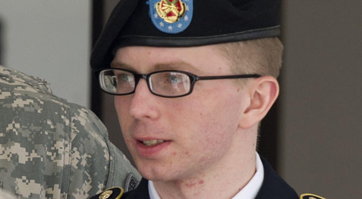 Army PFC Bradley Manning is escorted by military police as he departs the courtroom at Fort Meade, Maryland.