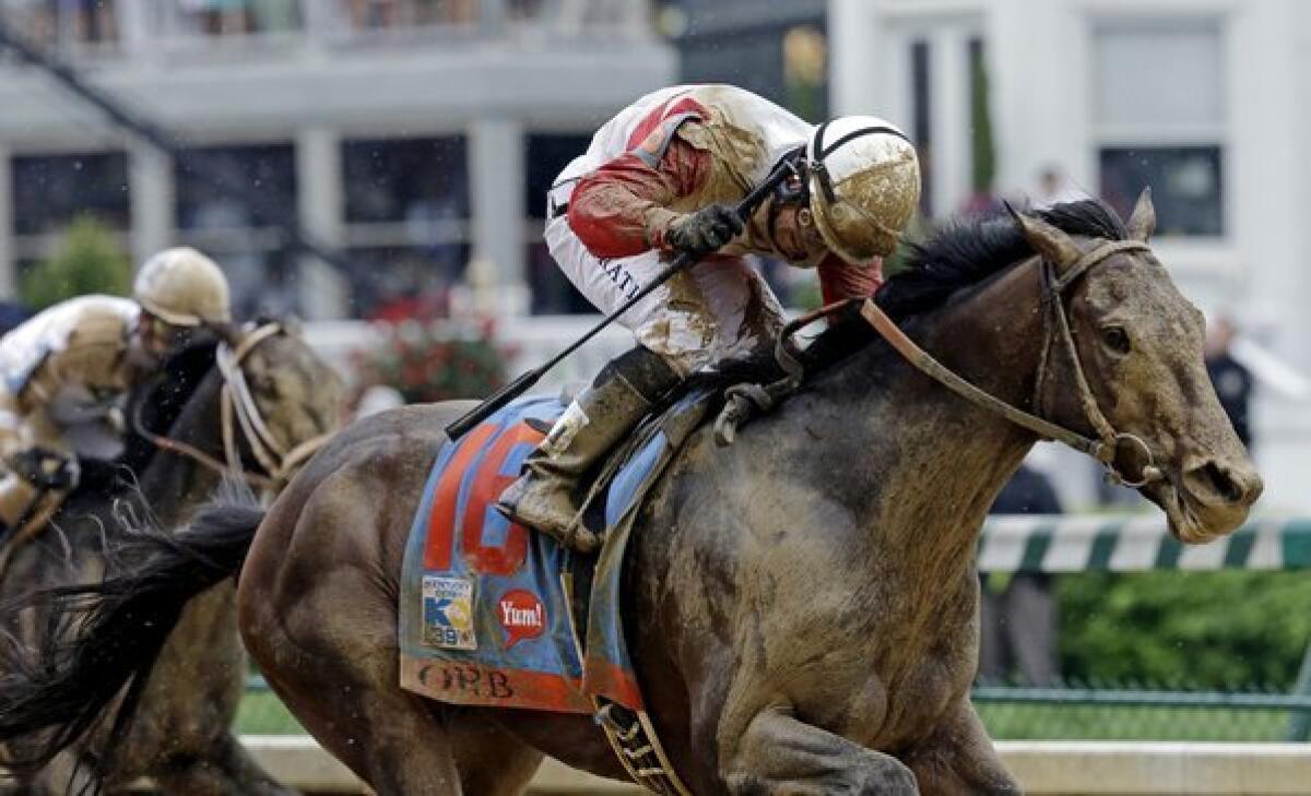 Jockey Joel Rosario guides Orb across the finish line for the victory in the 139th Kentucky Derby on Saturday at Churchill Downs.