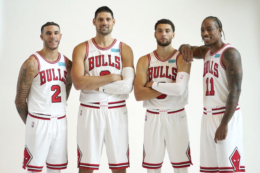 From left to right, Chicago Bulls' Lonzo Ball, Nikola Vucevic, Zach LaVine and DeMar DeRozan pose for photographers during the Bulls' NBA basketball media day Monday, Sept. 27, 2021, in Chicago. (AP Photo/Charles Rex Arbogast)