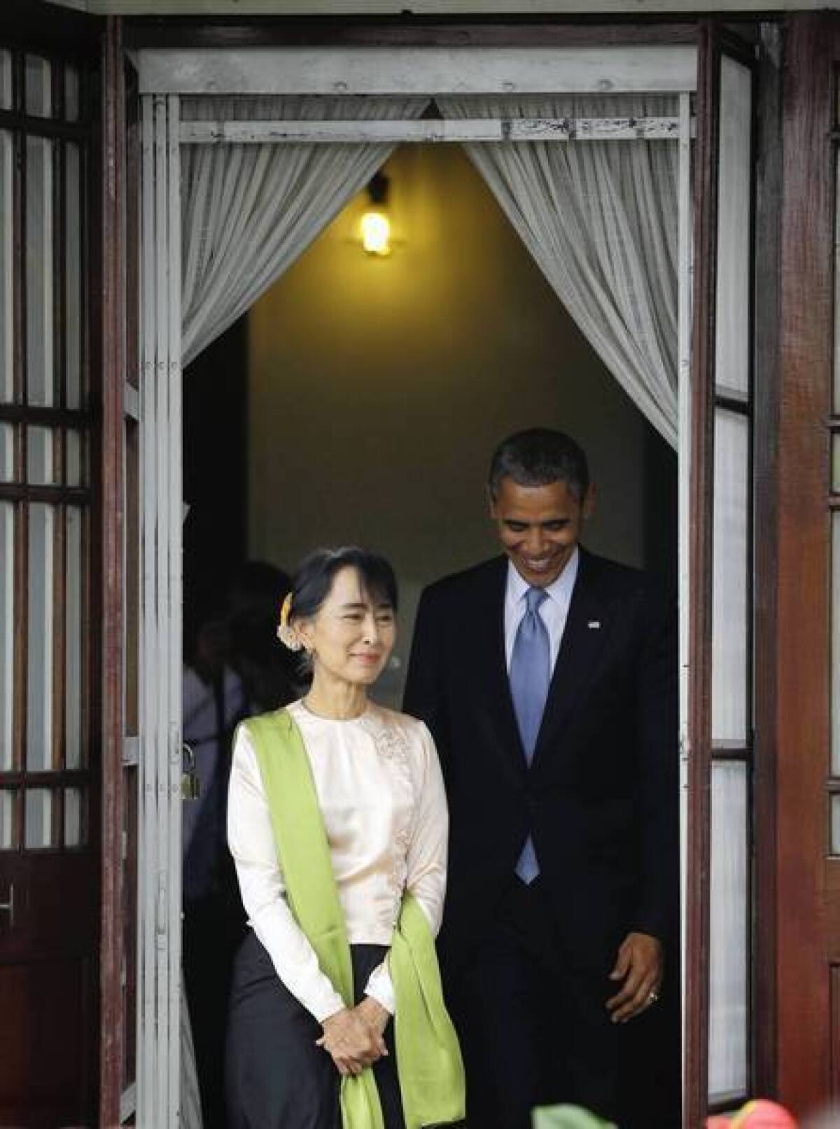 President Obama and Myanmar opposition leader Aung San Suu Kyi prepare to speak to the media at her home in Yangon.