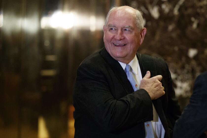 Former Georgia Gov. Sonny Perdue waits for an elevator in the lobby of Trump Tower in New York in November.