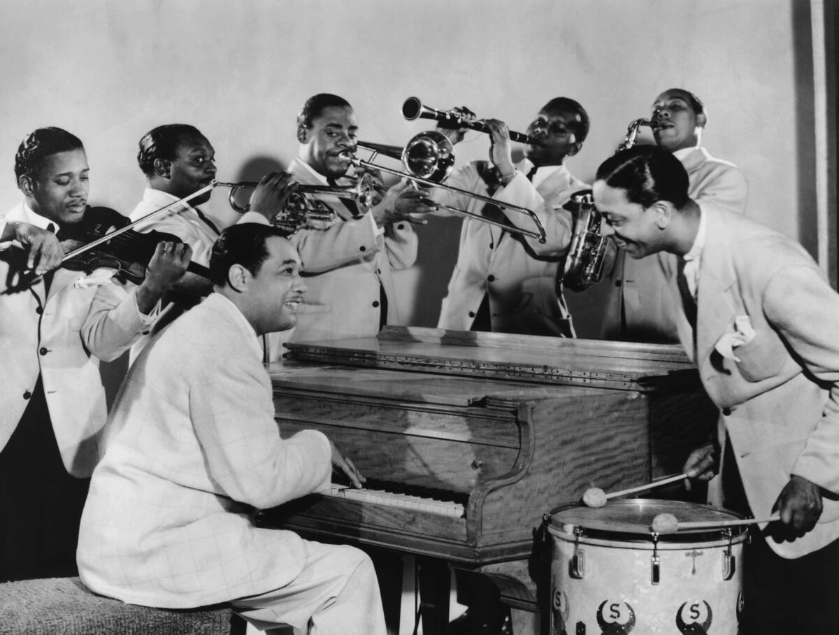 Duke Ellington at the piano with his band in 1945.