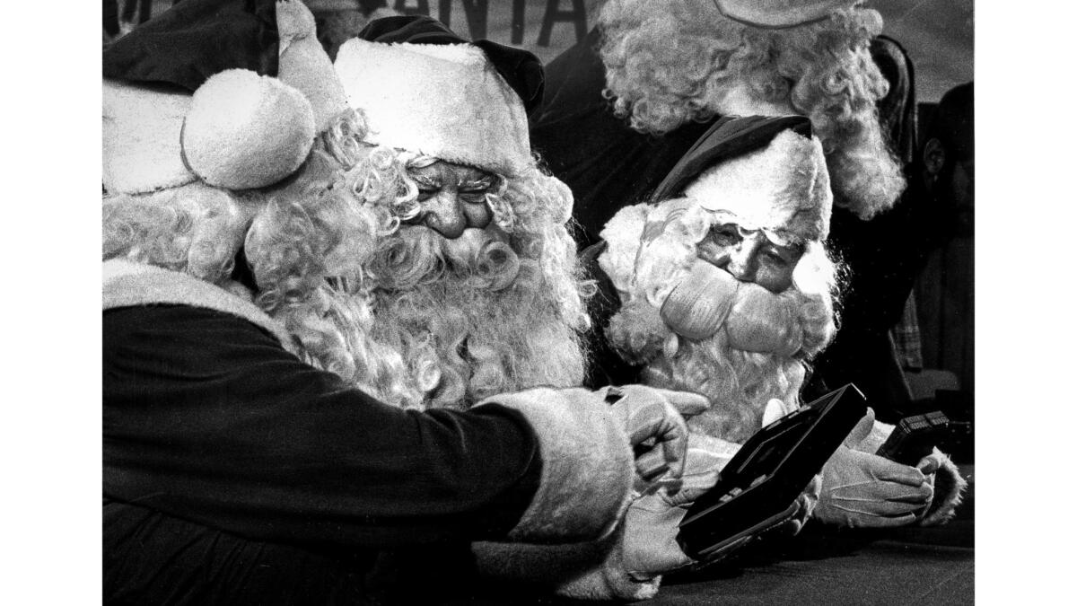 Nov. 21, 1979: Some of the 15 Santas taking part in a training class at Sears district headquarters in Alhambra get acquinted with some electronic games. "It's important that Santa keep his credibility" in knowing all about the toys, said Sears spokesman Nat Read.