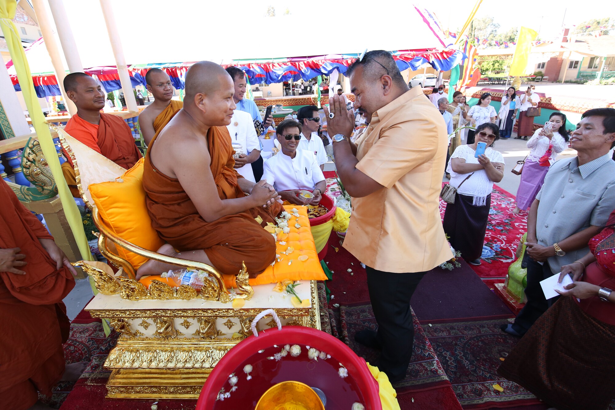 Danny Kim, right, gets a blessing from the temple abbot, Say Bunthon, left.