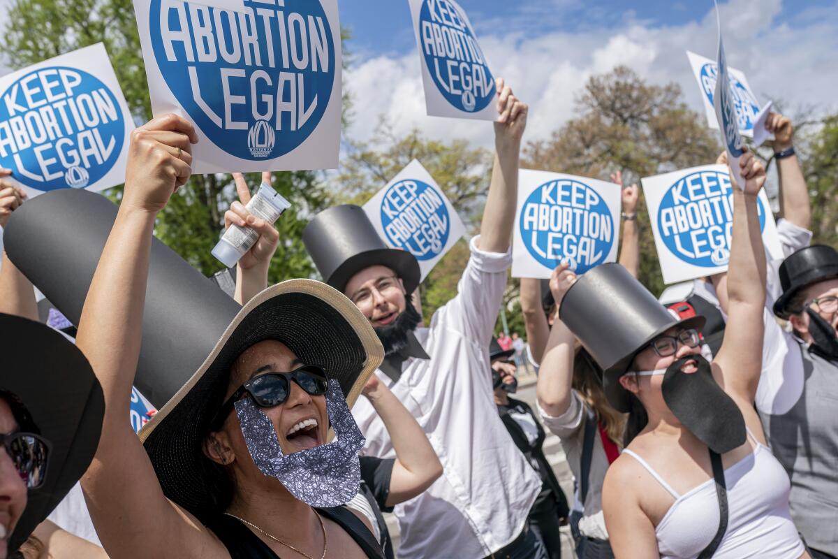 Demonstrators hold signs that say "Keep Abortion Legal"
