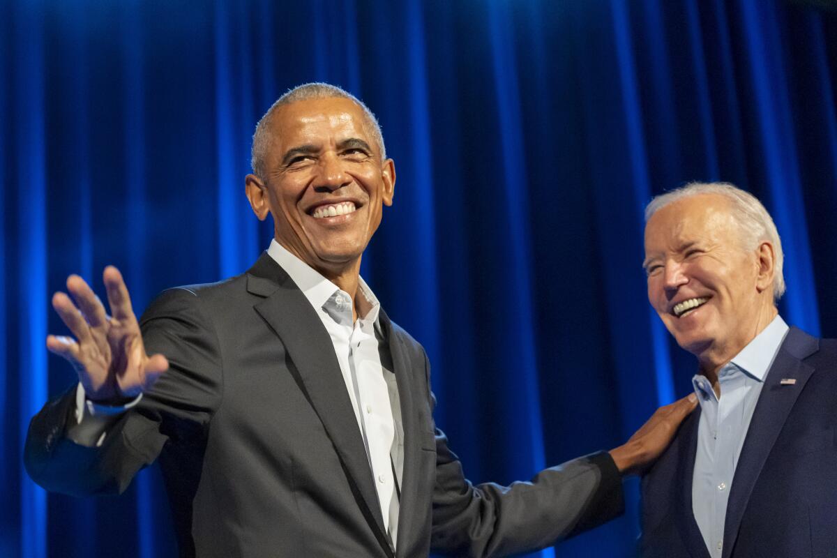 Barack Obama and Joe Biden sharing a laugh on stage
