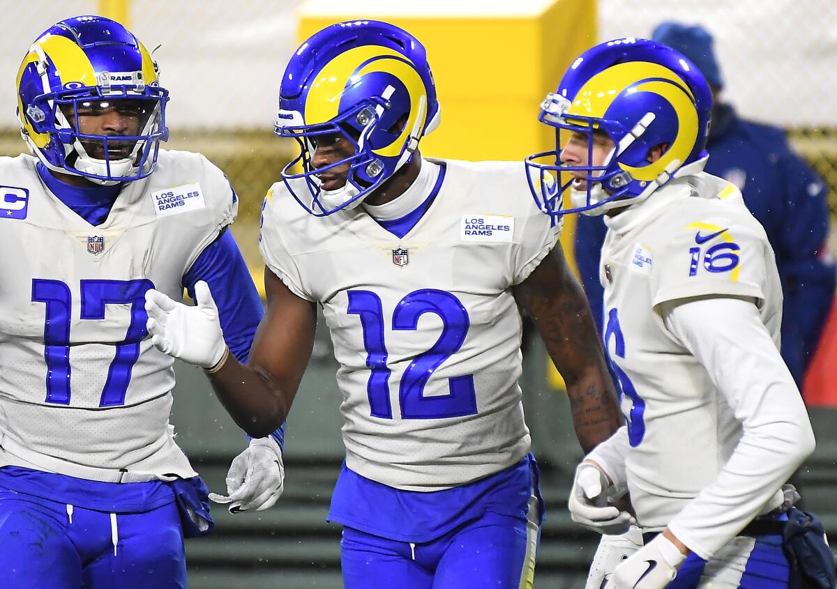 Rams receiver Van Jefferson (12) celebrates his touchdown catch with Robert Woods (17) and Jared Goff.