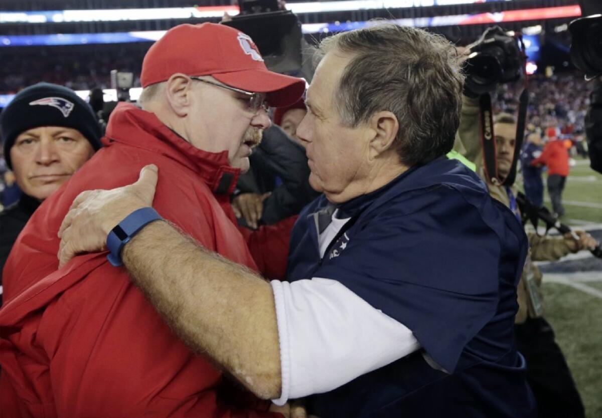 Former Glendale Community College offensive lineman and current Kansas City Chiefs Coach Andy Reid shakes hands with New England Patriots Coach Bill Belichick after the Chiefs' loss to the Patriots on Saturday.