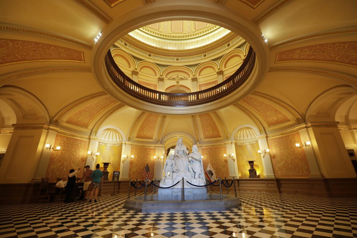 The statuary, "Columbus' Last Appeal to Queen Isabella," greets visitors to the rotunda at the Capitol building in Sacramento.